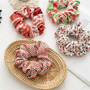 Set of 4 Christmas hair scrunchies with festive patterns including reindeer and candy canes