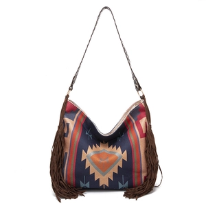 Detail of bohemian shoulder bag with geometric patterns and long brown side tassels