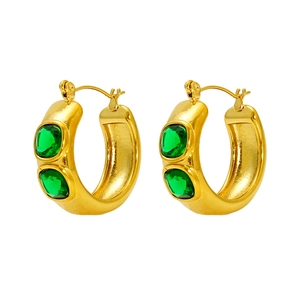 Detailed view of chunky 18K gold plated hoop earrings set with emerald green zircons