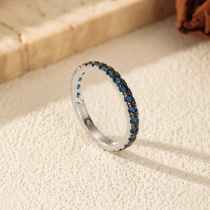Elegant S925 sterling silver eternity ring featuring round-cut deep blue gemstones