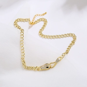 18K gold plated snake head pendant necklace with clear cubic zirconia on white background