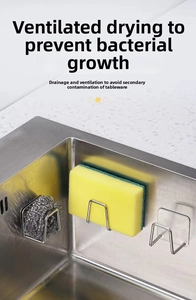 Detail of stainless steel sponge holder with wire ball in kitchen sink for drainage