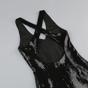 Detailed view of the sequined backless dress with crossed straps and shiny texture