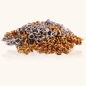 Close-up of stacked hip-hop cross chains in polished 18K gold and silver stainless steel