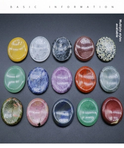Macro shot of fifteen polished natural crystal oval thumb stones in various quartz materials