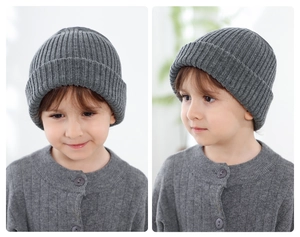 Detail of dark grey knit beanie for children featuring chunky ribbed cuff and warm texture