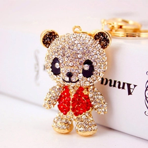 Sparkling panda car keychain with red rhinestone vest on a gold metal base charm