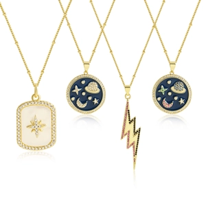 Detail of four 18k gold plated necklaces with star, lightning and evil eye charms