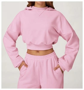 Detail of pink cropped hoodie with ribbed neck and matching jogger pants set
