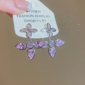 Macro view of pink zircon drop earrings with S925 silver studs and floral design