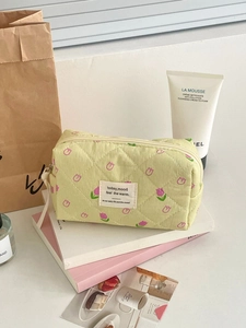Quilted floral makeup bag with pink tulip patterns and light green cotton fabric