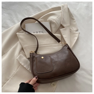 Detailed view of dark brown vintage faux leather shoulder bag with metallic clasp