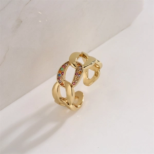 Detailed macro shot of gold-plated chain ring with multicolor cubic zirconia stones