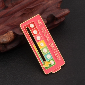 Detail of sliding social battery enamel pin with interactive lightning bolt on leather