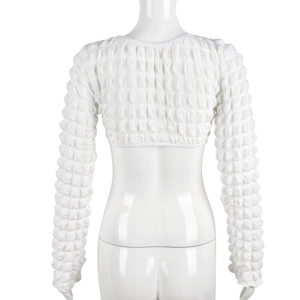 Detail of white long sleeve cropped top featuring unique bubble textured stretch fabric