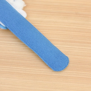 Detail shot of the blue felt texture and soft curved edges on the Christmas slap bracelet