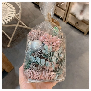 DIY Christmas kit with pink pine cones, silver glitter balls, and green foliage decor