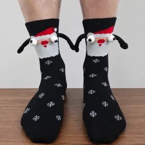 Detail of 3D Santa Claus socks with magnetic hands and festive snowflake patterns