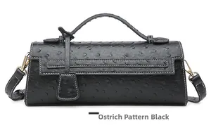 Close-up of black ostrich-embossed leather texture and white stitching on handbag