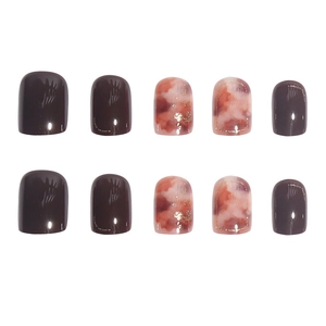 Short round press-on nails set with brown marble ink and gold foil accents