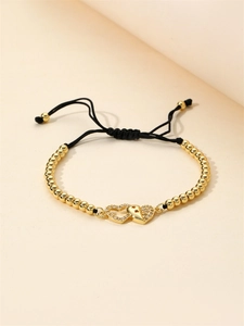 Adjustable woven bracelet with gold heart charms and sparkling colorful cubic zirconia