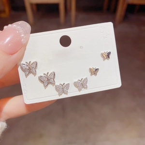 Three-piece sparkling silver butterfly stud earring set with zircons on display card