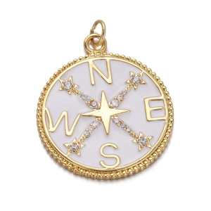 Macro view of a gold compass pendant with white enamel, cubic zirconia and NESW letters