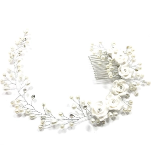 Close-up of bridal hair comb with handmade ceramic flowers, pearls and rhinestones
