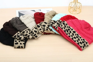 Flat lay of knit beanies in multiple colors featuring stylish leopard print fold-over cuffs