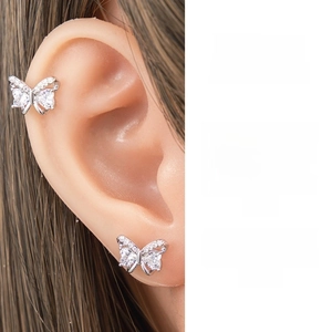 Macro shot of silver butterfly stud earrings set with sparkling cubic zirconia stones