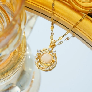 Golden starry planet necklace featuring amber cat-eye stone and pavé zircon accents
