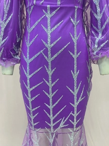 Detail of purple evening gown featuring silver sequin branches and mesh long sleeves