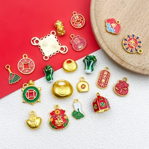 Macro shot of gold DIY lucky charms with enamel details for jewelry and keychains