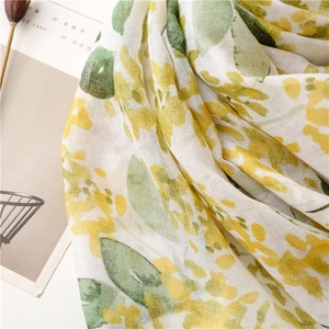 Close-up of yellow floral leaf print on lightweight cotton linen blend scarf texture