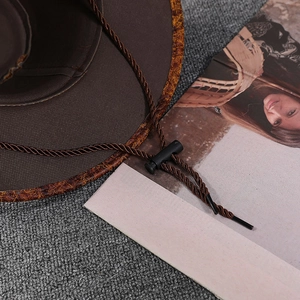 Deep brown Western cowboy hat with adjustable windproof rope and textured brim