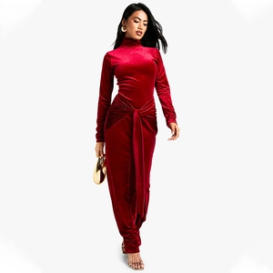 Detailed close-up of a red velvet slim fit dress with turtleneck and waist tie knot design