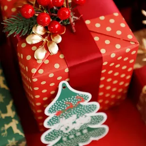 Christmas DIY floral wrapping paper with gold polka dots and a Merry Christmas tag