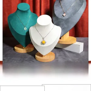 Three-color velvet necklace display busts with premium wooden bases on red velvet