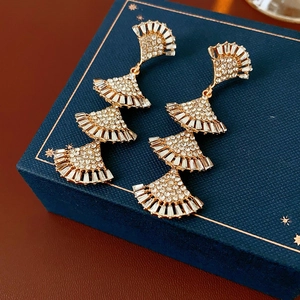Macro shot of tiered fan tassels with sparkling rhinestones in a gold finish