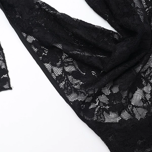 Macro shot of black floral lace texture with intricate mesh details on women's dress