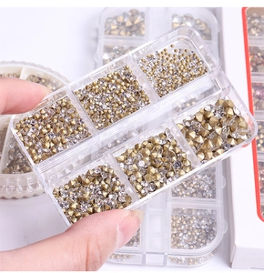 Detail of 6-slot clear storage box filled with golden and clear nail art rhinestones