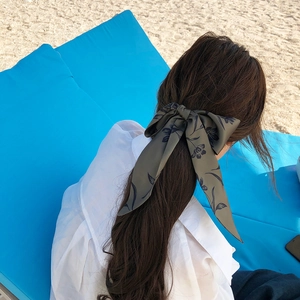 Army green floral scarf headband tied in a bow style for women on the beach