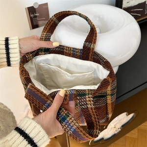 Detail of the large checkered wool tote bag showing white lining and interior pocket