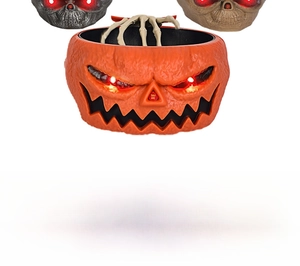 Macro shot of Halloween candy bowl with glowing eyes and interactive skeletal hand detail
