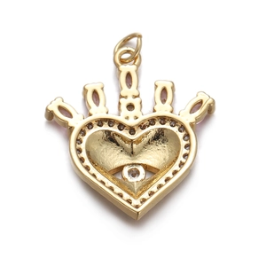 Macro shot of gold heart crown pendant with clear crystals and metallic shine