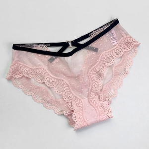 Close-up of pink lace mesh panties with polka dots and heart-shaped metal detail