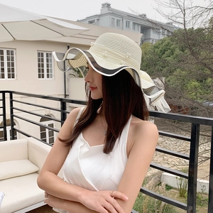 Elegant wide-brim straw sun hat with pearls and mesh bow for summer beach vacation