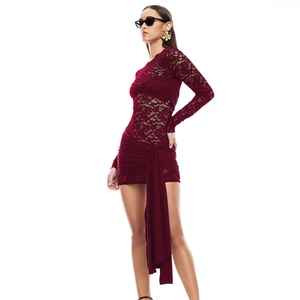 Close-up of burgundy lace patchwork and side drawstring detail on a slim mini dress
