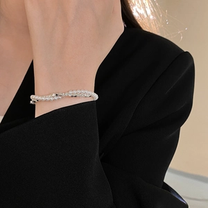 Close-up of double-layer bracelet with white pearls and silver beads on female wrist