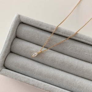 Close-up of S925 sterling silver marquise zircon necklace on a grey velvet jewelry box